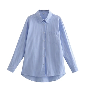 Detailed macro view of the blue and white vertical striped cotton shirt with chest pocket