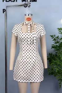 Gros plan d'une robe rétro à pois avec encolure carrée et détail de nœud papillon