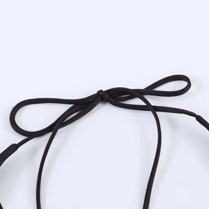 Close-up of black spaghetti straps with fine woven texture and neat knot detail