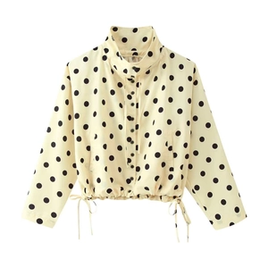 Detail of vintage beige polka dot jacket showing stand collar and drawstring waist hem