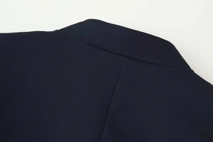 Close-up of the back neckline and shoulder texture on a navy blue slim-fit jacket