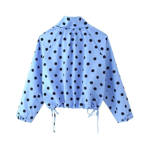 Detail view of light blue polka dot jacket showing drawstring hem and elastic waistband