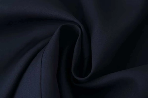 Detailed close-up of premium black twill fabric showing the texture of the slim fit jacket
