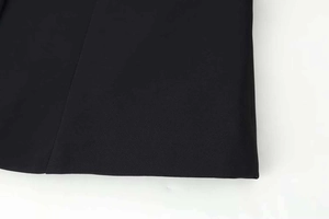 Close-up of black fitted blazer featuring premium woven fabric and neat stitching detail