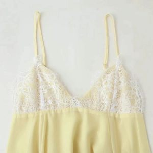 Elegant light yellow lace slip dress with adjustable straps and white floral trim