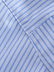 Close-up of blue and white striped fabric with premium reinforced stitching detail