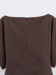 Detail view of deep chocolate puff sleeve top with concealed back zipper and textured fabric