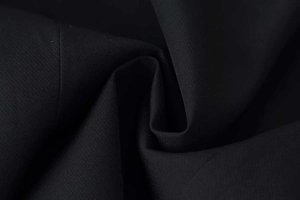 Close-up of premium black fabric texture with fine weave for women's short sleeve blazer