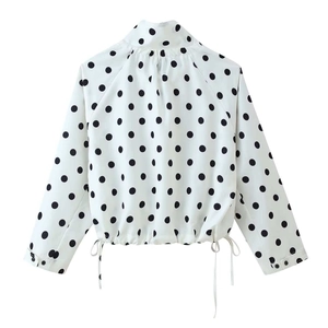 Back view of a white polka dot jacket featuring a stand collar and drawstring hem details