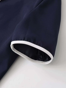 Detail of navy blue sleeve cuffs with white contrast piping and smooth inner lining