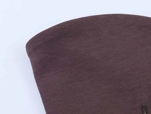 Gros plan détaillé du tissu en maille marron foncé montrant la texture jersey mat doux