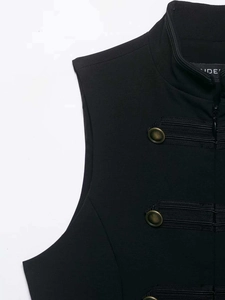 Detail of vintage black vest featuring copper buttons and ribbed trim decoration