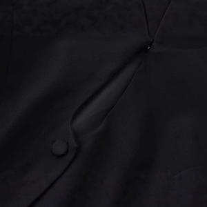 Elegant black slim-fit blazer featuring covered buttons and keyhole cutout detail