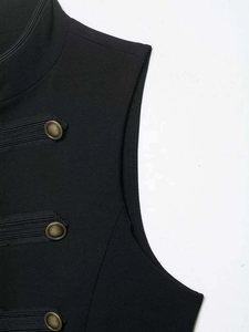 Close-up of vintage black vest featuring textured stripes and bronze embossed metal buttons