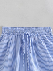 Detail of blue and white striped shorts with elastic waistband and drawstring
