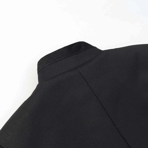 Detail of mandarin collar and ribbed texture on stylish black women's short jacket