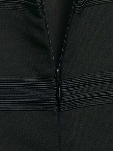 Detailed macro view of the invisible zipper and ribbed texture on this black vest
