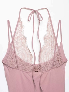 Detail of dusty pink lace bodysuit featuring halter neck ties and delicate floral mesh embroidery