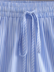 Detailed macro view of blue and white striped shorts featuring elastic waist and drawstring