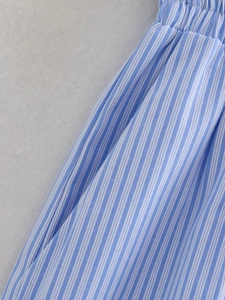 Close-up of blue and white striped fabric with elastic waistband and textile texture