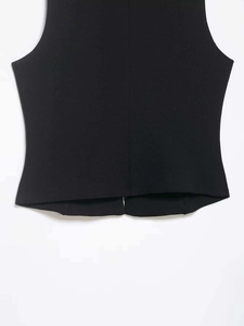 Detailed view of the back seam and hemline on a black stand-collar vest for women