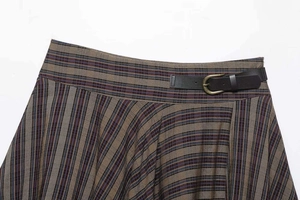 Detail view of woven plaid A-line skirt featuring dark brown faux leather belt and gold buckle
