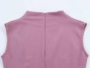 Detail view of the high-neck sleeveless top with back hidden zipper and textured fabric