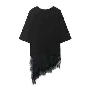Detailed close-up of the asymmetric lace trim and delicate eyelash edge on a black T-shirt