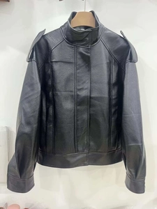 Detail shot of black faux leather bomber jacket with stand collar and epaulets on shoulders