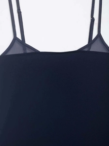Detail of navy blue camisole featuring sheer mesh patchwork and adjustable spaghetti straps