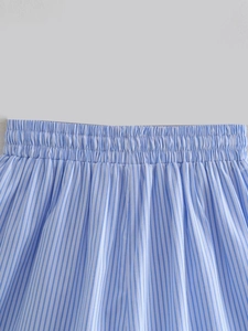 Detail of the elastic waistband on blue and white striped cotton fabric shorts