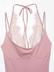 Detailed view of pink lace patchwork bodysuit with eyelash lace trim and halter neck straps