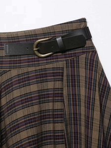 Detail of vintage brown plaid skirt featuring a black belt with antique bronze round buckle