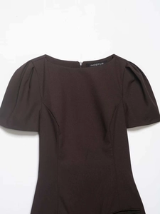 Detailed view of dark brown boat neck dress with puff sleeves and back invisible zipper