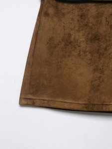Close-up of brown suede fabric showing high-quality stitching and texture details