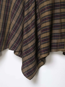 Close-up of vintage plaid fabric with brown, blue, and burgundy woven textures