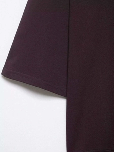 Close-up of deep purple T-shirt sleeve showing fine stitching and cotton knit texture