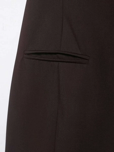 Close-up of the professional welt pocket detail and woven fabric texture on a slim dress