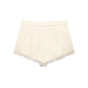 Women's high waist cream satin shorts with delicate white lace trim on a white background