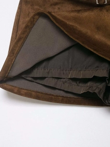 Close-up of brown faux suede skirt featuring built-in safety lining and stitching