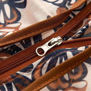 Detail shot of the metal zipper closure on a vintage floral printed sun protection jacket