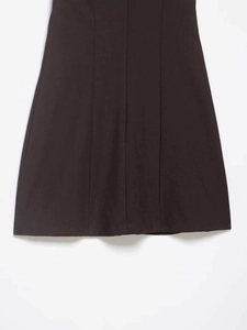 Detailed close-up of coffee brown dress featuring textured fabric and panel stitching