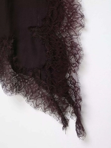 Close-up of deep purple satin fabric with delicate eyelash lace trim and refined texture