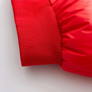 Close-up of bright red quilted fabric and ribbed cuff detail on winter thermal two-piece set