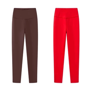 Close-up of seamless high-waist yoga leggings in dark brown and bright red colors