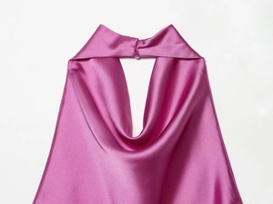 Detail of fuchsia satin halter top featuring a smooth silky texture and draped neckline