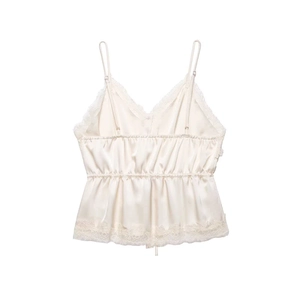 Close-up of cream lace camisole featuring a V-neckline and elastic pleated waist detail