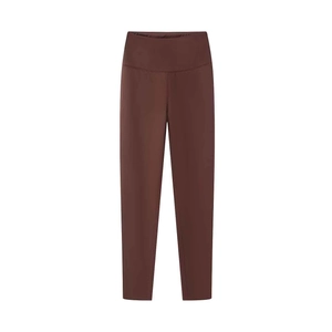 Detail showing high-waist yoga pants in dark brown with slimming elastic fabric