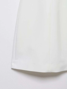 Detailed macro view showing the clean stitching and durable white fabric of the dress hemline