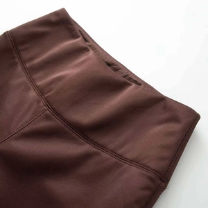 Close-up of brown high-waisted yoga pants showing premium stitching and fabric texture